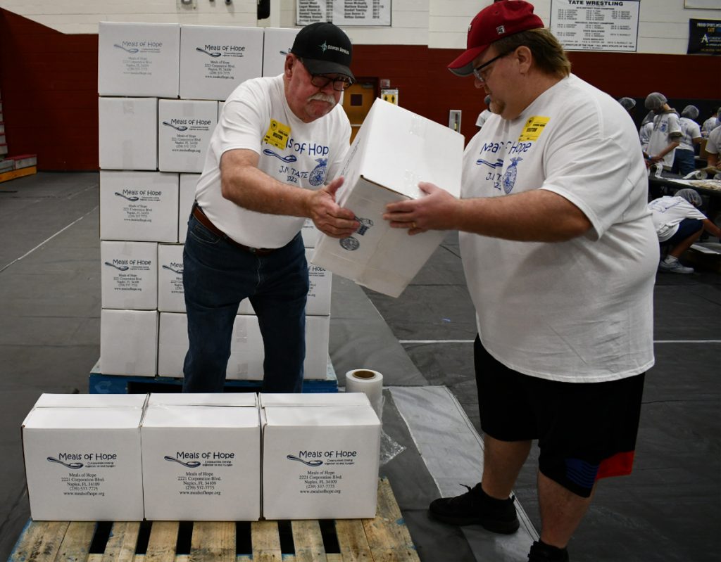 men carrying boxes hurricane ian