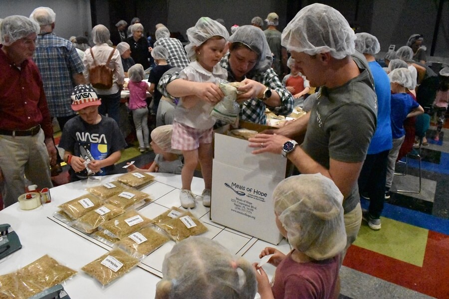 kids and adults packing meals